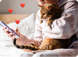A photo of a person embracing their cat. Hearts indicate social likes are happening.