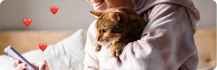A photo of a person embracing their cat. Hearts indicate social likes are happening.